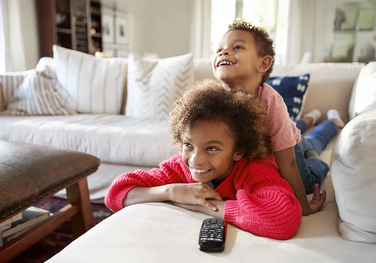 Two kids sitting and streaming their favorite show.